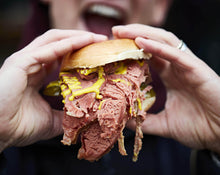 Load image into Gallery viewer, A packed salt beef bagel. Our bagels come from brick lane bakery but your local deli may sell traditional bagels or beigels